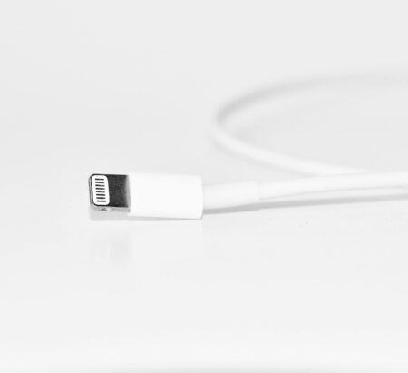 Minimalist close-up of a white charging cable, useful for tech themes.